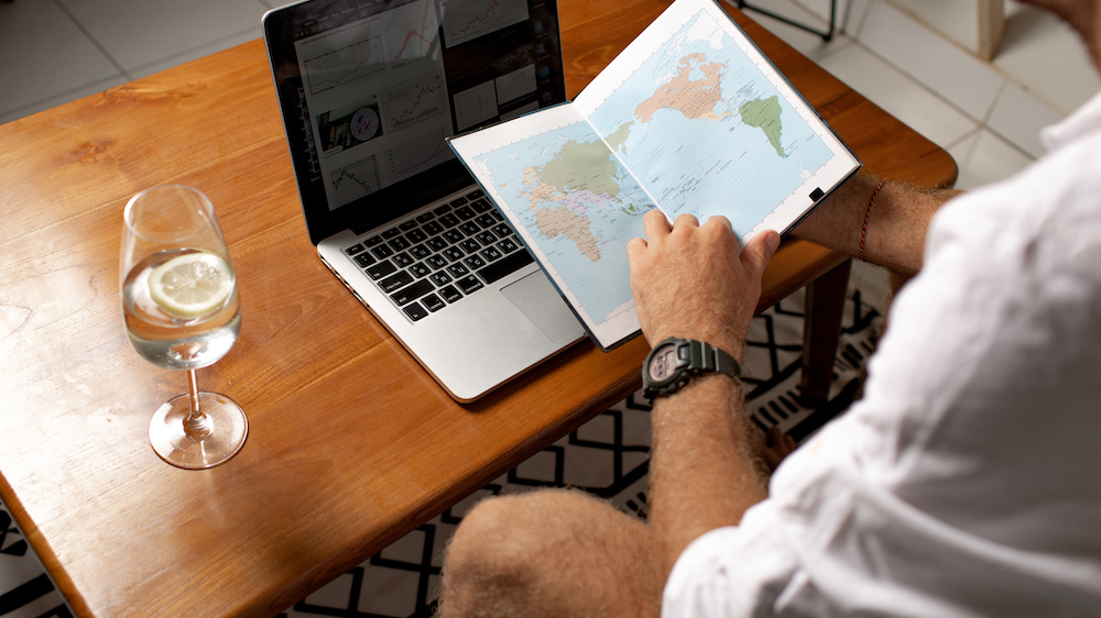 Solo traveler planning their next adventure with maps and guidebooks.