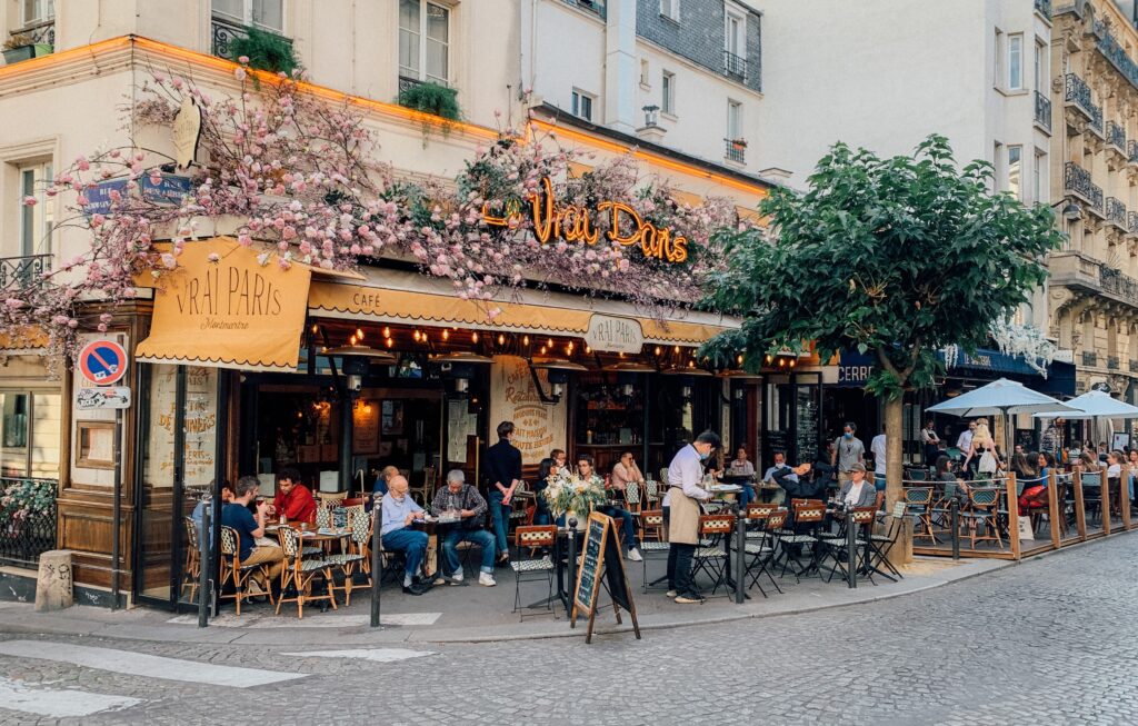 Cozy French bistro with outdoor seating, showcasing a lively street scene in Paris