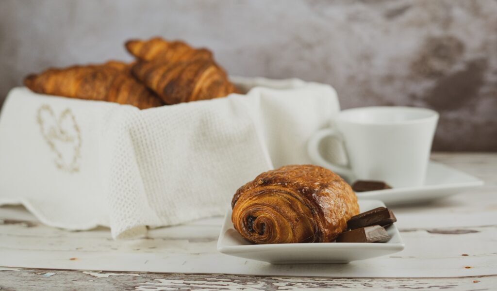 Assortment of French pastries and desserts on a table at a Parisian cafe