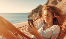Lady using mobile phone on beach. Jollylog.com