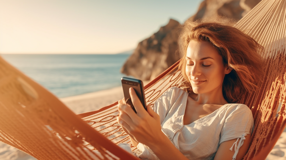 Lady relaxing on beach with mobile - Jollylog.com